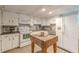 Bright kitchen with white appliances, a speckled backsplash, and a butcher block kitchen island at 7234 Post Rd, Winston, GA 30187