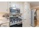 Well-equipped kitchen with stainless steel appliances, gas range, and stylish white cabinetry at 7234 Post Rd, Winston, GA 30187