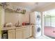 Efficient laundry room featuring a utility sink, cabinetry, and stacked washer/dryer units, maximizing space at 7234 Post Rd, Winston, GA 30187