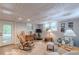 Cozy living room with a textured ceiling, rocking chair, plush seating, and a view of the backyard at 7234 Post Rd, Winston, GA 30187