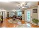 Spacious living room with hardwood floors, ceiling fans, and traditional furnishings at 7234 Post Rd, Winston, GA 30187