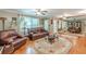 Inviting living room featuring hardwood floors, leather furniture, and an ornate rug at 7234 Post Rd, Winston, GA 30187