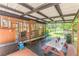 Covered patio with seating, a grill, and screened-in porch, ideal for outdoor entertaining at 7234 Post Rd, Winston, GA 30187