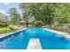 Backyard oasis featuring a large in-ground pool, diving board, and lounge chairs at 7234 Post Rd, Winston, GA 30187