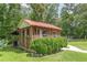 The screen porch in backyard has a red metal roof and offers peaceful outdoor living at 7234 Post Rd, Winston, GA 30187