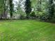 Well-maintained backyard surrounded by mature trees and lush greenery at 876 Pinehurst Sw Ter, Atlanta, GA 30310