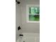 Modern bathroom featuring neutral tiling, a window, and black hardware at 876 Pinehurst Sw Ter, Atlanta, GA 30310