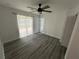 Bright bedroom boasts wood-look floors, ceiling fan and sliding glass door to deck at 876 Pinehurst Sw Ter, Atlanta, GA 30310