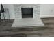 Close-up of a modern fireplace with gray stone surround and light gray hearth at 876 Pinehurst Sw Ter, Atlanta, GA 30310
