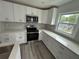 Beautiful white kitchen with modern stainless steel appliances and light gray countertops at 876 Pinehurst Sw Ter, Atlanta, GA 30310