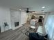 Open-concept living room with stone fireplace, modern furniture, and updated kitchen with island at 876 Pinehurst Sw Ter, Atlanta, GA 30310