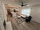 Spacious living room with fireplace, ceiling fan, and modern open kitchen with a kitchen island at 876 Pinehurst Sw Ter, Atlanta, GA 30310