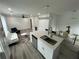 Open living area with a modern kitchen island, dining area, and cozy living room at 876 Pinehurst Sw Ter, Atlanta, GA 30310
