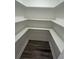 Walk-in closet has laminate floors and built-in shelves at 876 Pinehurst Sw Ter, Atlanta, GA 30310
