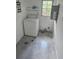 Laundry room with a washing machine, tile floor, and natural light from the window at 1048 Seals Rd, Dallas, GA 30157