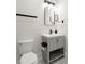 Small bathroom featuring tile floors, a mirror, and a toilet at 1057 Fortress Sw Ave, Atlanta, GA 30315