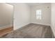 Carpeted bedroom with an open doorway and a window with blinds at 1057 Fortress Sw Ave, Atlanta, GA 30315