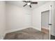 Neutral bedroom featuring a ceiling fan, neutral carpet, and white trim at 1057 Fortress Sw Ave, Atlanta, GA 30315