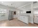 Open-concept kitchen with stainless steel refrigerator and a kitchen bar at 1057 Fortress Sw Ave, Atlanta, GA 30315