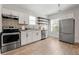 Bright kitchen with stainless steel appliances, white cabinets, and a stylish backsplash at 1057 Fortress Sw Ave, Atlanta, GA 30315