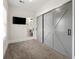 Stylish main bedroom boasting closet barn doors and a modern ensuite bathroom with a tv at 1057 Fortress Sw Ave, Atlanta, GA 30315