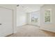 This carpeted bedroom is bathed in light from a large window with wooded outdoor views at 1986 Cobblestone Ne Cir, Atlanta, GA 30319