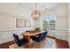 Dining room boasts modern lighting, wood table, and wainscoting detail at 1986 Cobblestone Ne Cir, Atlanta, GA 30319