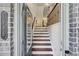Welcoming entryway featuring hardwood floors, a staircase, and stylish decor at 1986 Cobblestone Ne Cir, Atlanta, GA 30319