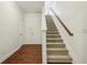Inviting hallway with hardwood and carpeted floors leading to a staircase with wooden handrail at 1986 Cobblestone Ne Cir, Atlanta, GA 30319