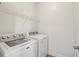 This laundry room features a modern washer and dryer, and wire rack shelving for storage at 1986 Cobblestone Ne Cir, Atlanta, GA 30319