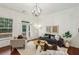 Bright living room with hardwood floors, recessed lighting, a modern light fixture and access to an outdoor deck at 1986 Cobblestone Ne Cir, Atlanta, GA 30319