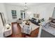 Well-lit living room with hardwood flooring, a modern light fixture, and is connected to the kitchen space at 1986 Cobblestone Ne Cir, Atlanta, GA 30319