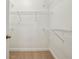 Empty walk-in closet featuring white wire shelves, beige carpet, and white colored walls at 1986 Cobblestone Ne Cir, Atlanta, GA 30319