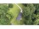 Birds-eye view highlighting the long driveway and abundant surrounding foliage at 3975 N Sharon Church N Rd, Loganville, GA 30052