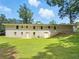 Rear view of the house showcasing the white brick and the expansive backyard at 3975 N Sharon Church N Rd, Loganville, GA 30052