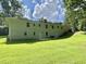 Spacious backyard featuring a brick home with a walkout basement and a lush green lawn, ideal for outdoor enjoyment at 3975 N Sharon Church N Rd, Loganville, GA 30052