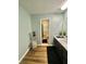 Well-lit bathroom features a sink, vanity, and wood floors at 3975 N Sharon Church N Rd, Loganville, GA 30052