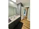 Well-lit bathroom features a sink, vanity, and wood floors at 3975 N Sharon Church N Rd, Loganville, GA 30052