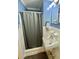 Blue bathroom with a shower featuring tiled walls and a window for natural light at 3975 N Sharon Church N Rd, Loganville, GA 30052