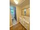 Bathroom with vanity, mirror and view of the second bathroom with a patterned shower curtain at 3975 N Sharon Church N Rd, Loganville, GA 30052