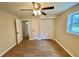 Bright bedroom featuring hardwood floors, ceiling fan, and a window with natural light at 3975 N Sharon Church N Rd, Loganville, GA 30052