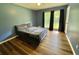 Spacious bedroom featuring wood floors and a large window at 3975 N Sharon Church N Rd, Loganville, GA 30052