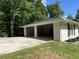 Attached two-car carport with a concrete driveway and manicured flowerbeds enhance the exterior of this home at 3975 N Sharon Church N Rd, Loganville, GA 30052