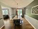 Spacious dining room with chandelier, modern wall decor and view into living room at 3975 N Sharon Church N Rd, Loganville, GA 30052