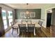 Elegant dining room with chandelier, matching wall decor, and natural light at 3975 N Sharon Church N Rd, Loganville, GA 30052