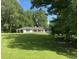 A house with a well-manicured lawn and a backdrop of lush trees at 3975 N Sharon Church N Rd, Loganville, GA 30052