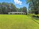 Ranch-style home with a huge lawn, and a treeline backdrop at 3975 N Sharon Church N Rd, Loganville, GA 30052