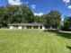 Inviting single-story home with a large, well-maintained front lawn and mature trees, offering a serene environment at 3975 N Sharon Church N Rd, Loganville, GA 30052