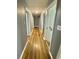Long hallway with wood floors that connects the various areas of the house at 3975 N Sharon Church N Rd, Loganville, GA 30052