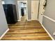 Hallway featuring durable flooring, connecting to a room with a refrigerator and ample storage space at 3975 N Sharon Church N Rd, Loganville, GA 30052